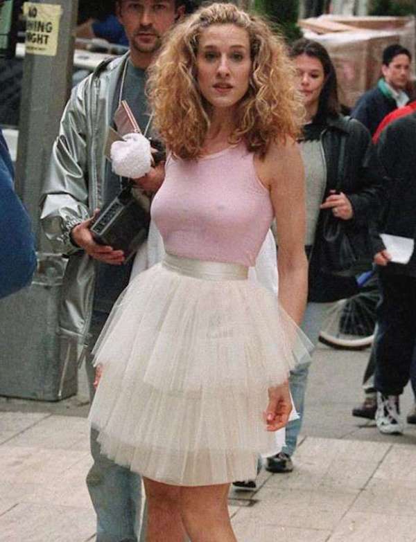 Scene from the opening Sex and the City theme song showing lead character Carrie Bradshaw, played by Sarah Jessica Parker, stylishly navigating the bustling streets of New York City in a whimsical pink tulle tutu