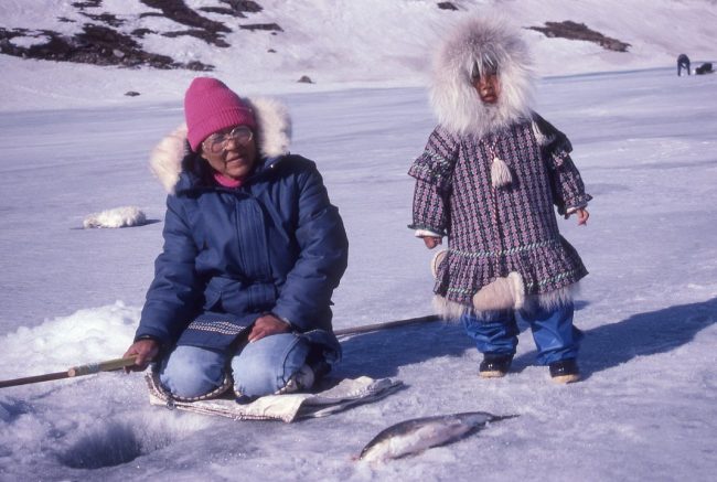 Alaska Native mother and child in traditional parkas in Alaska